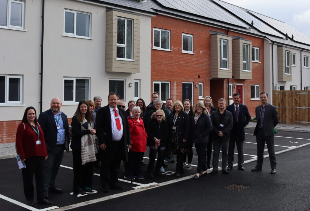 Picture of a group standing in front of new homes