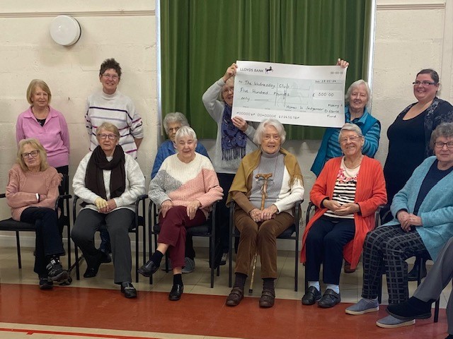 Members of a community group receive a cheque